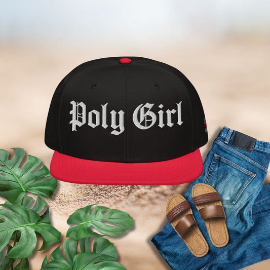 Black and red cap with 'Poly Girl' text, paired with jeans and sandals on a neutral background.