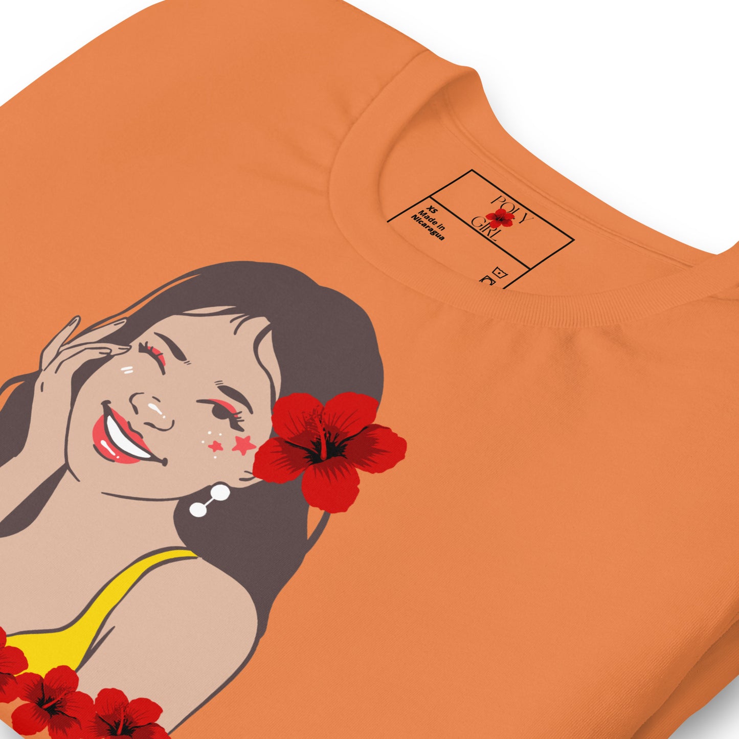 Folded front view of Wahine U'i t-shirt in burnt orange by Poly Girl