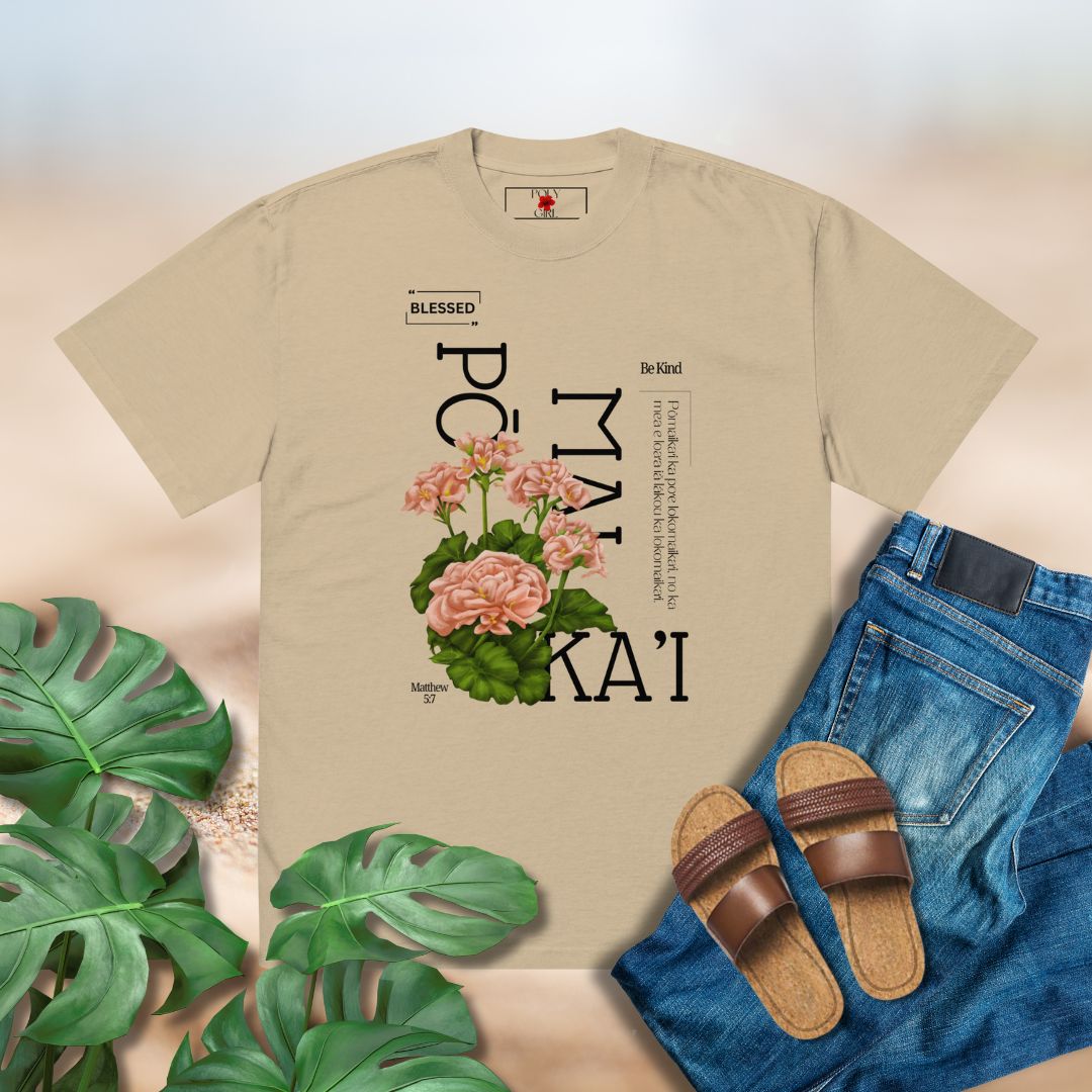 Beige t-shirt with floral design and text, paired with jeans and sandals on a light background