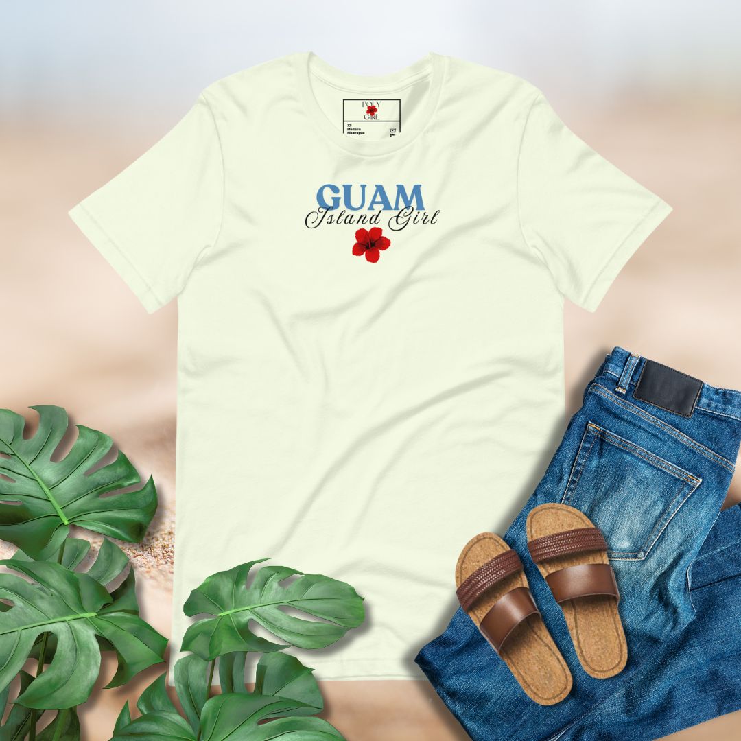 Citron t-shirt with 'GUAM Island Girl' design, paired with jeans and sandals on a light background.