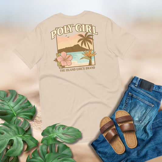Beige t-shirt with 'Poly Girl' graphic design of Diamond Head, ocean, palm tree an tropical plans, surrounded by green leaves and blue jeans.