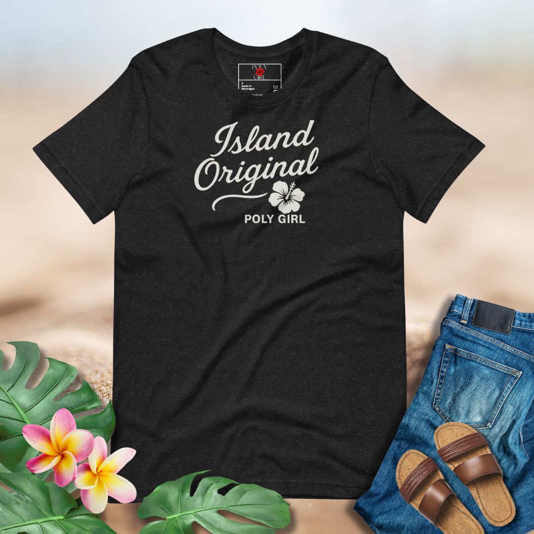 Black t-shirt with 'Island Original Poly Girl' text and floral design, placed on a neutral background with floral and denim elements.