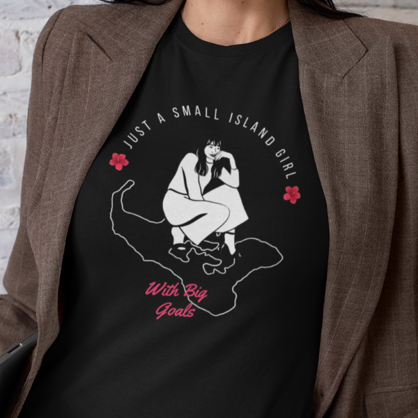 A woman wearing a black tshirt with a design of a woman kneeling on the Tongan map with the text "Just a small island girl with big goals" and a brown jackert.