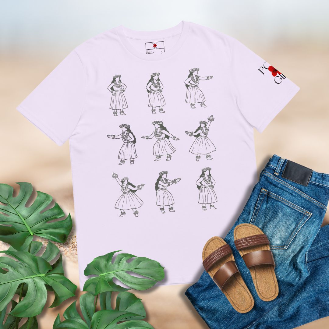 White t-shirt with black graphics of Hawaiian Kahiko dancers, set agains a background with blue jeans, brown sandals, and green leaves on a light wooden surface.