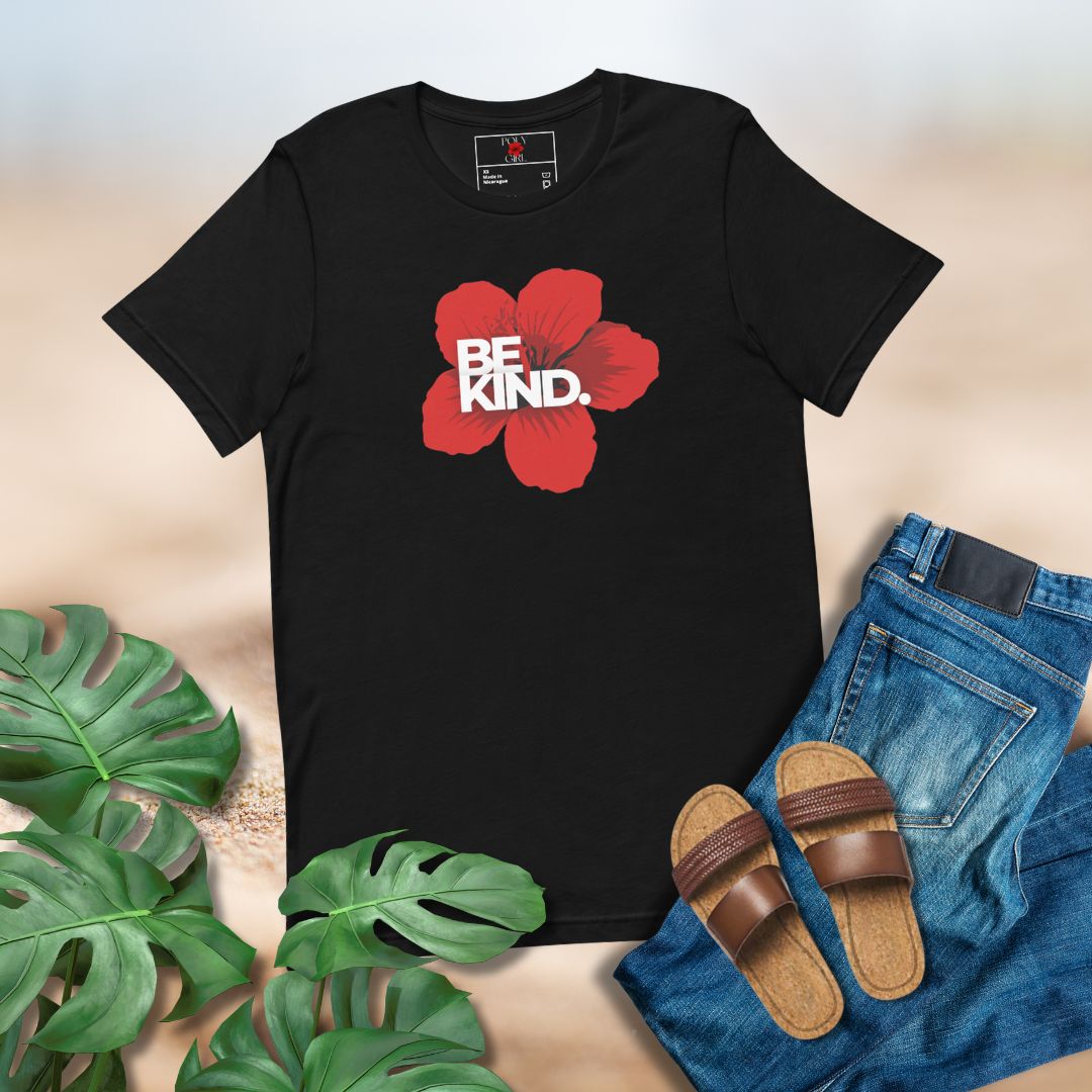 Black t-shirt with red flower and 'BE KIND' text, paired with jeans and sandals on a neutral background.