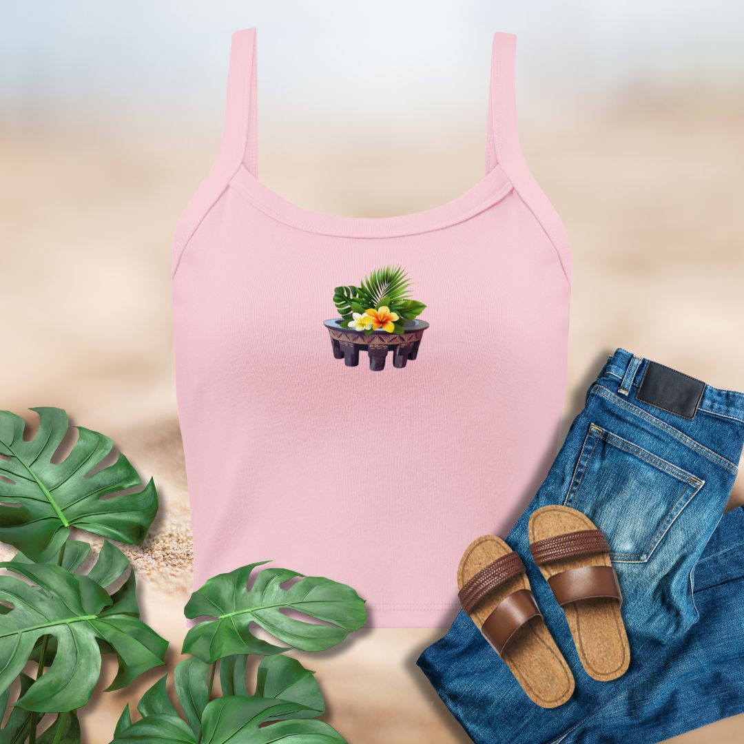 Pink tank top with a plant design, blue jeans, brown sandals, and green leaves on a light background