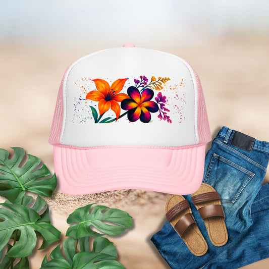Pink trucker hat with floral design on a neutral background with plants and sandals.