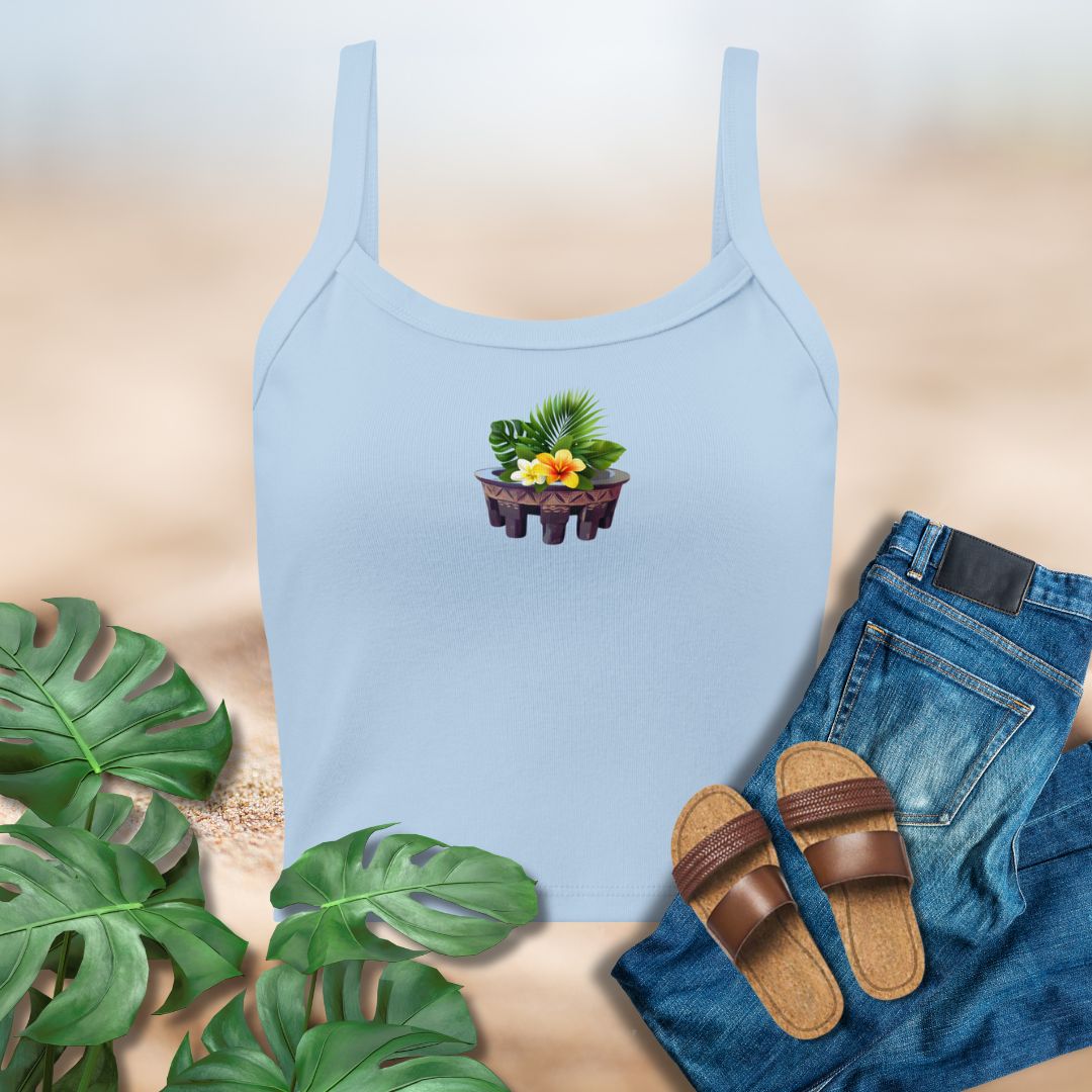 Light blue tank top with a plant design, paired with jeans and sandals on a neutral background.