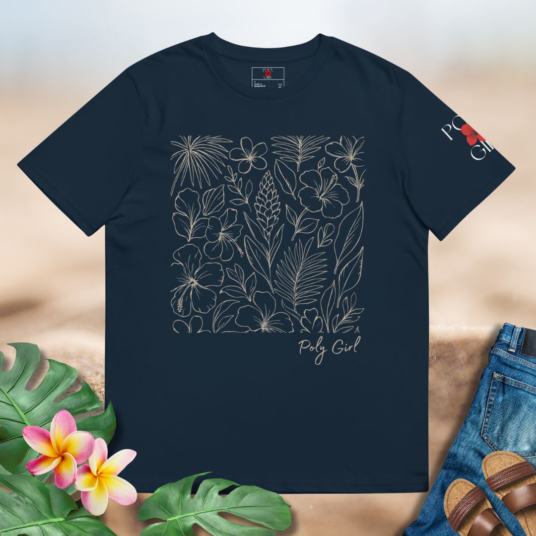 Navy blue t-shirt with floral design and 'Poly Girl' text, placed on a wooden surface with plants and sandals.