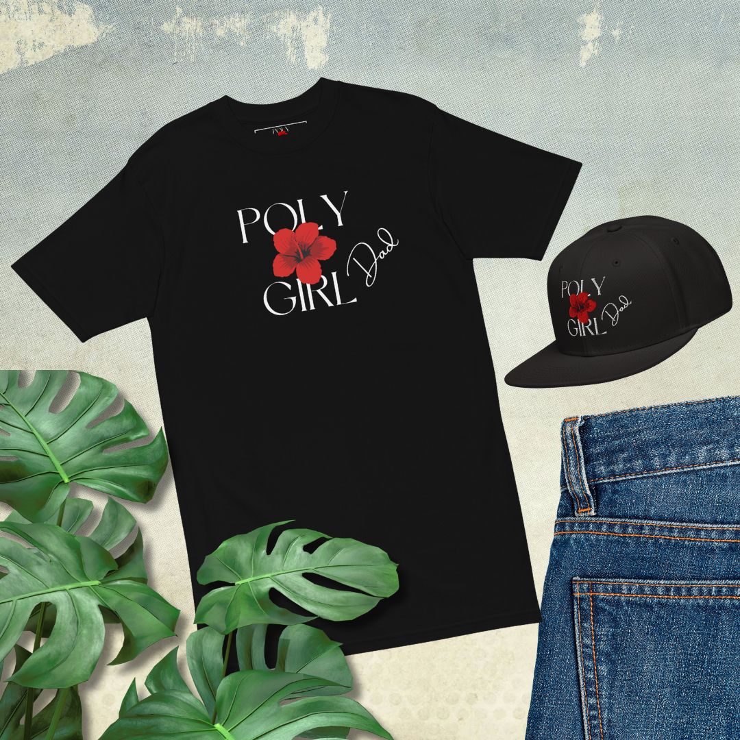 Mens' Black T-shirt and Baseball Hat with Poly Girl logo and Dad written on them paired jeans on gray background with tropical leaves. Poly Girl, The Island Girl's brand.