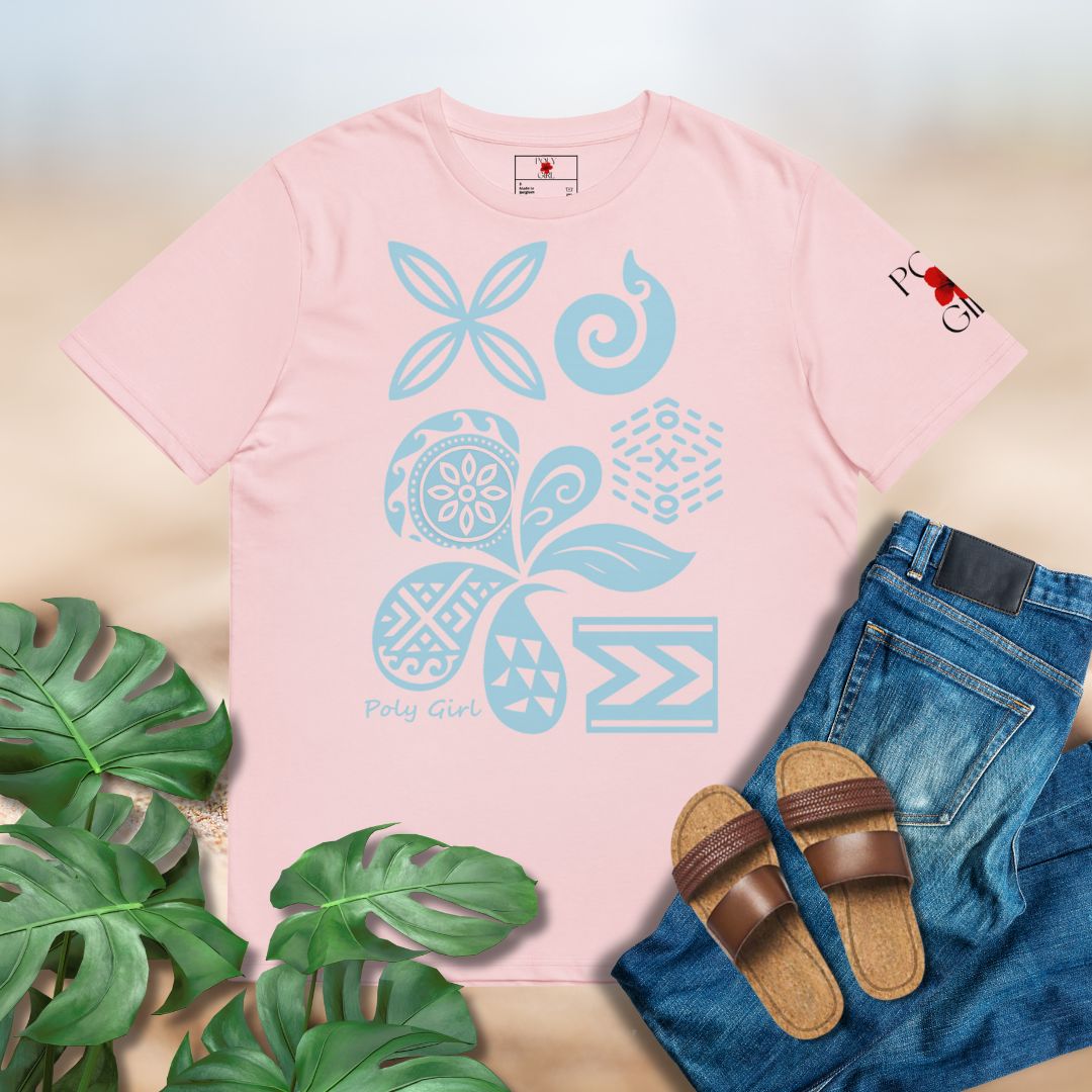 Pink t-shirt with blue floral design, jeans, sandals, and green leaves on a light background