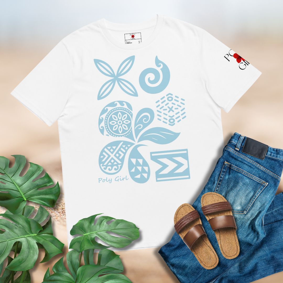 White t-shirt with blue floral patterns of Polynesian and Pacific Island motifs paired with jeans and sandals on a light surface.