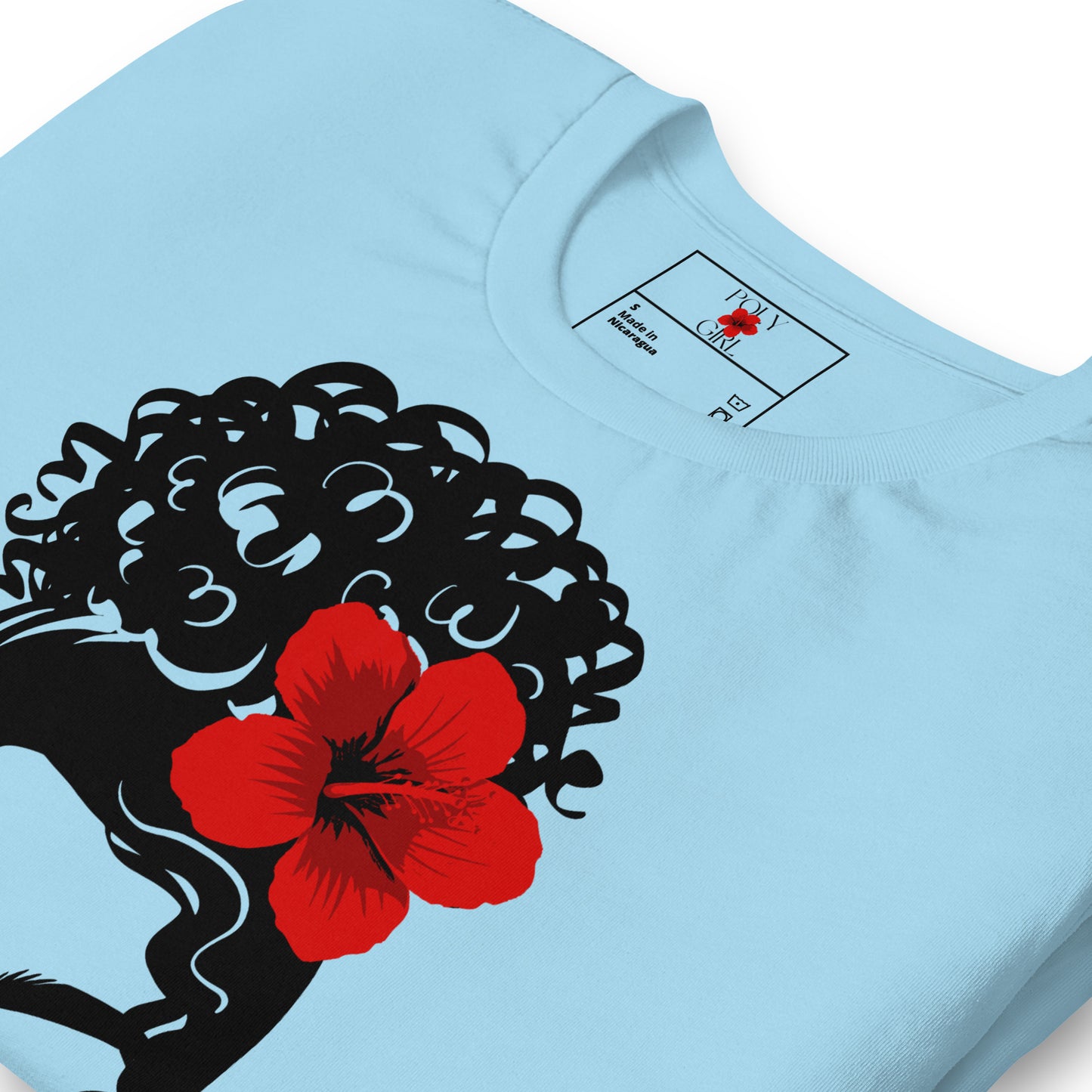 Front and folded view of a baby blue tshirt with the design of a woman with an updo with red hibiscus sei