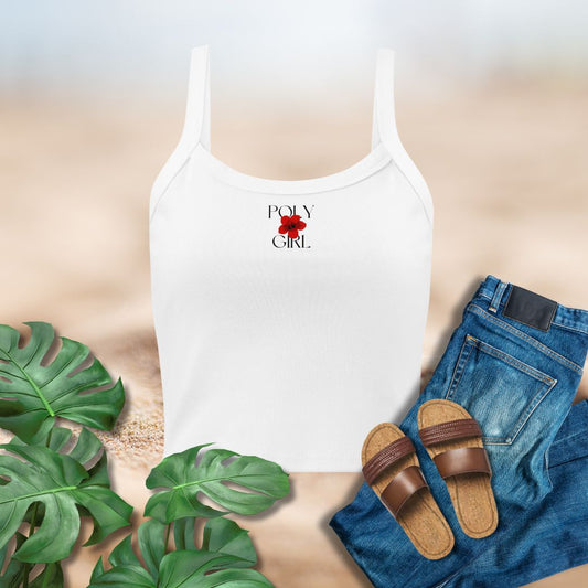 White tank top with 'Poly Girl' design, blue jeans, brown sandals, and green leaves on a neutral background