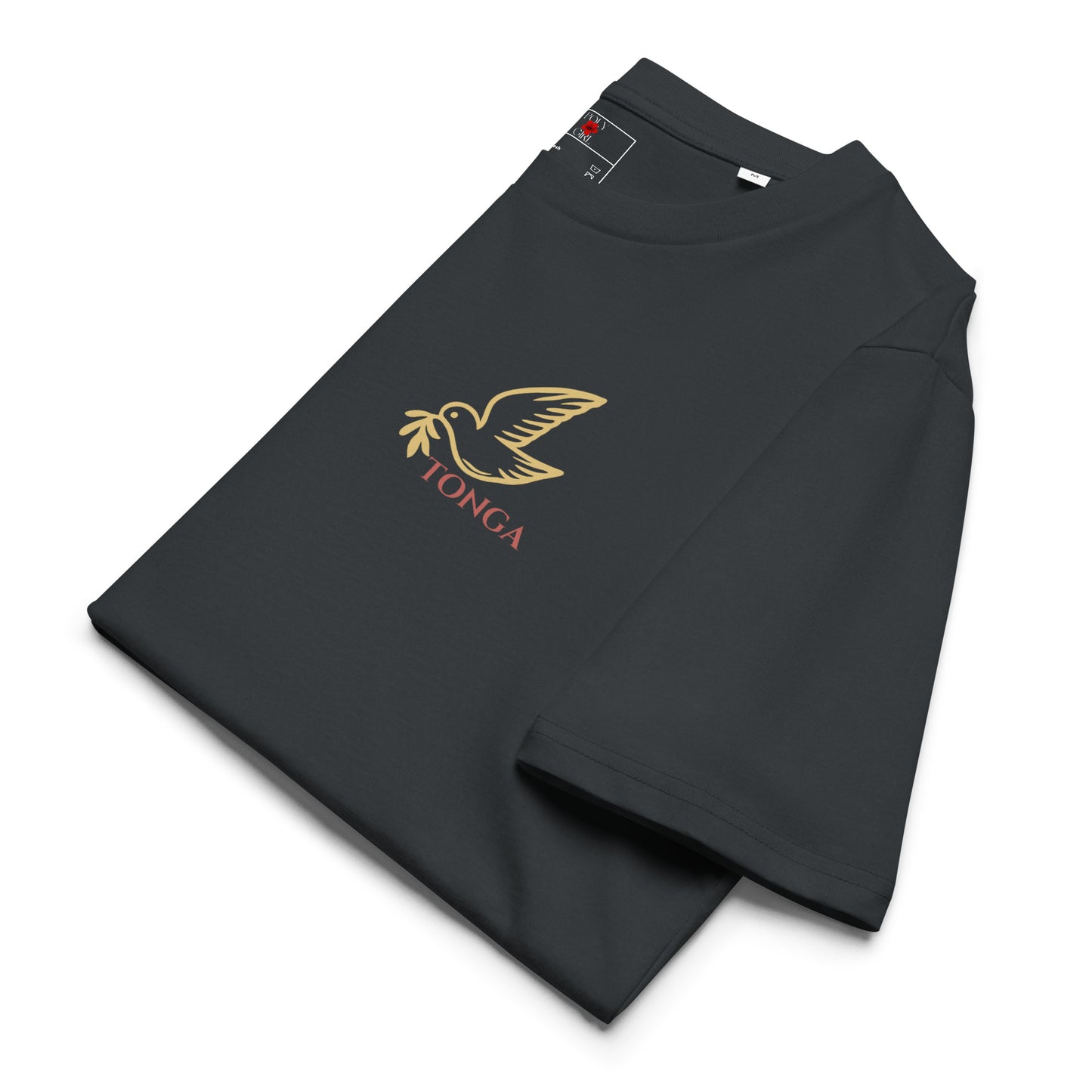 Close-up of Poly Girl Ko Hoku Tofi’a dark gray T-shirt, folded, with image of a dove in gold outline from the Tongan seal, printed on front chest pocket area.