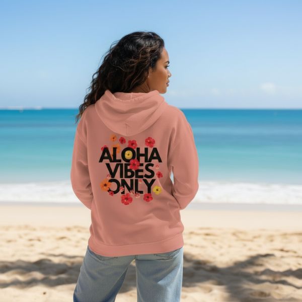 Person wearing a dustry rose hoodie  by Poly Girl with 'Aloha Vibes Only' text on the beach