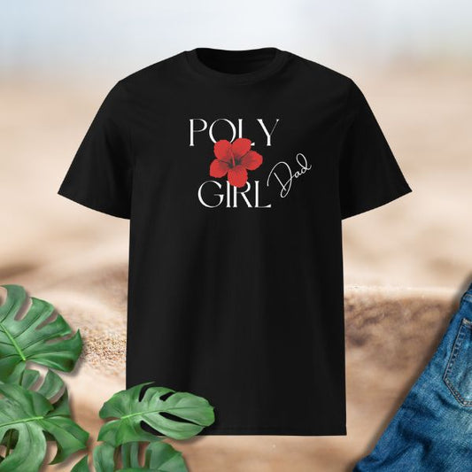 Black t-shirt with 'Girl Dad' text and red flower graphic on a textured surface with leaves and jeans.