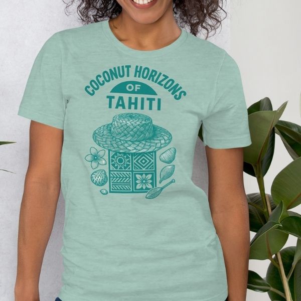 Modle wewaring Tahiti-inspired graphic tee showing a papale niu hat, island patterns, and coconut elements