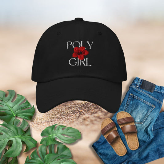 Black dad hat cap with 'Poly Girl' design, sandals, jeans, and plants on a neutral background