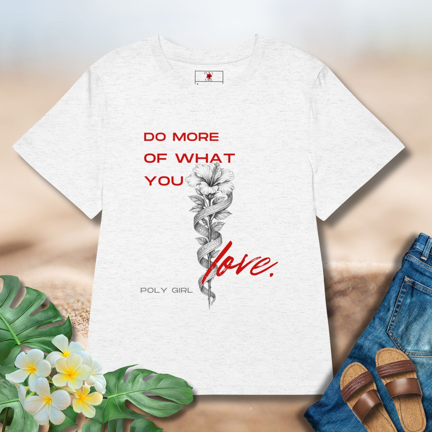 Light Gray tshirt with the design of a white hibiscus and tapa with the words Do More Of What You Love