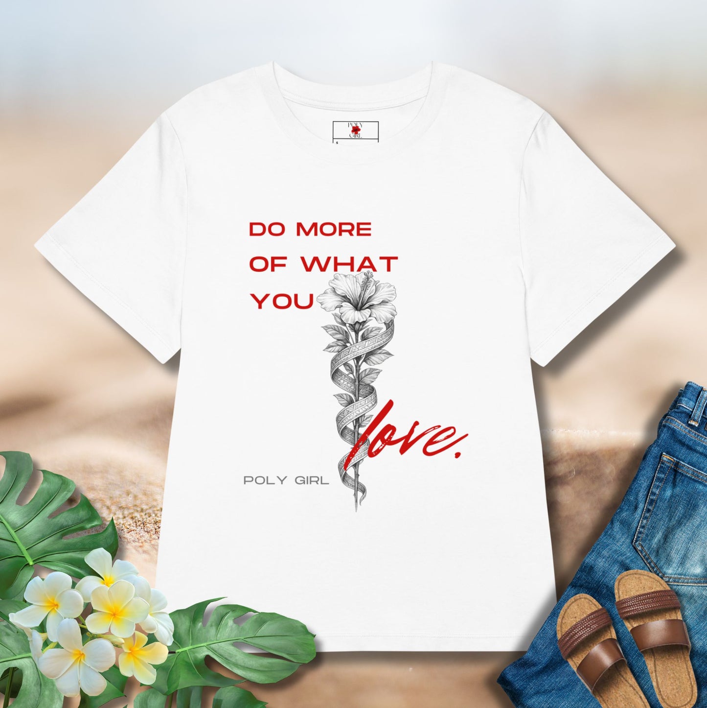 White tshirt with the design of a white hibiscus and tapa with the words Do More Of What You Love