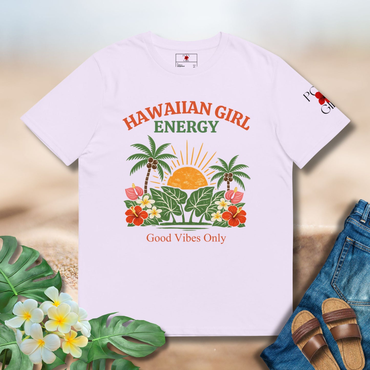Lavender t-shirt with 'Hawaiian Girl Energy' design on a wooden surface with flowers and sandals.