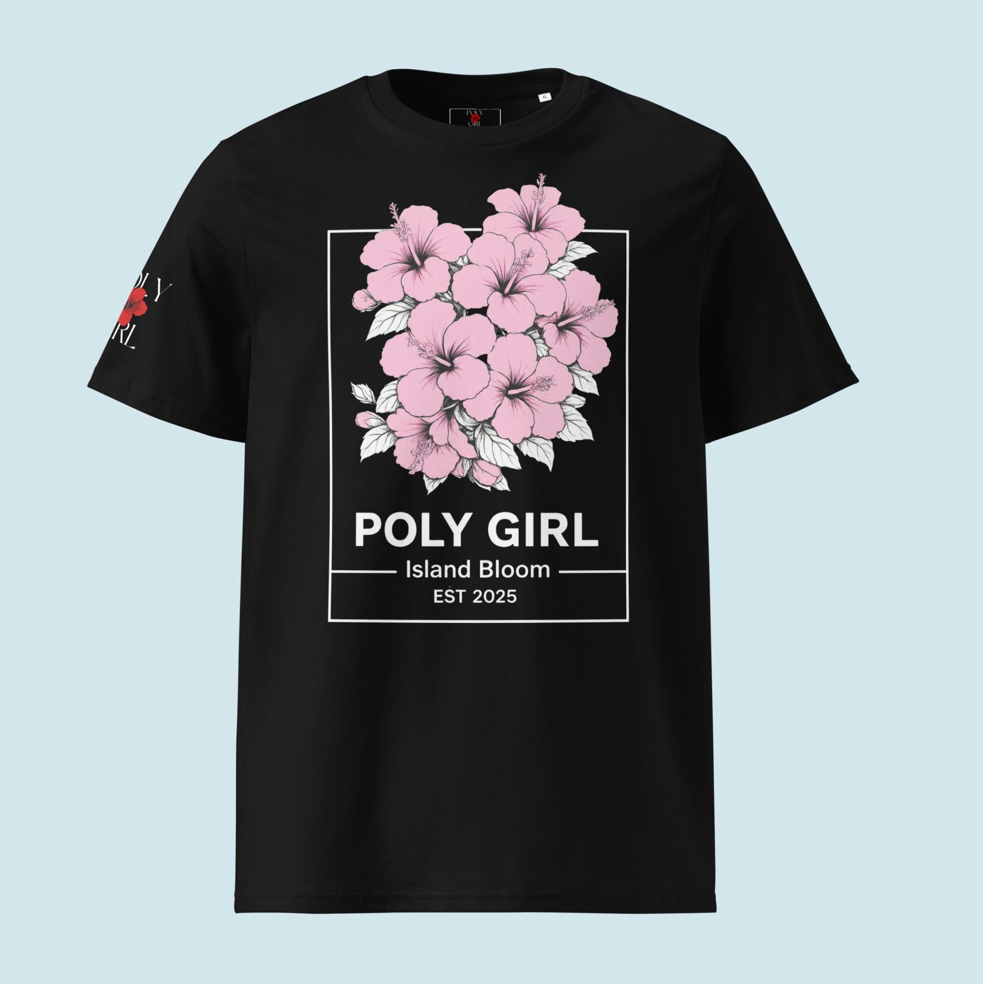 Close up of Vintage Island Bloom Tee with clusters of pink hibiscus in white outline and Poly Girl name and Island bloom EST 2025 on the bottom. 