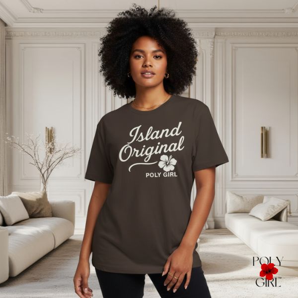 Woman wearing a 'Island Original Poly Girl' t-shirt in a stylish room.