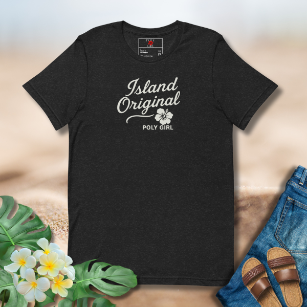 Black t-shirt with 'Island Original' text and brand logo on a sandy background with floral and denim elements.