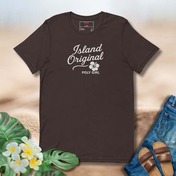 Brown t-shirt with 'Island Original' text on a sandy background with flowers and sandals.