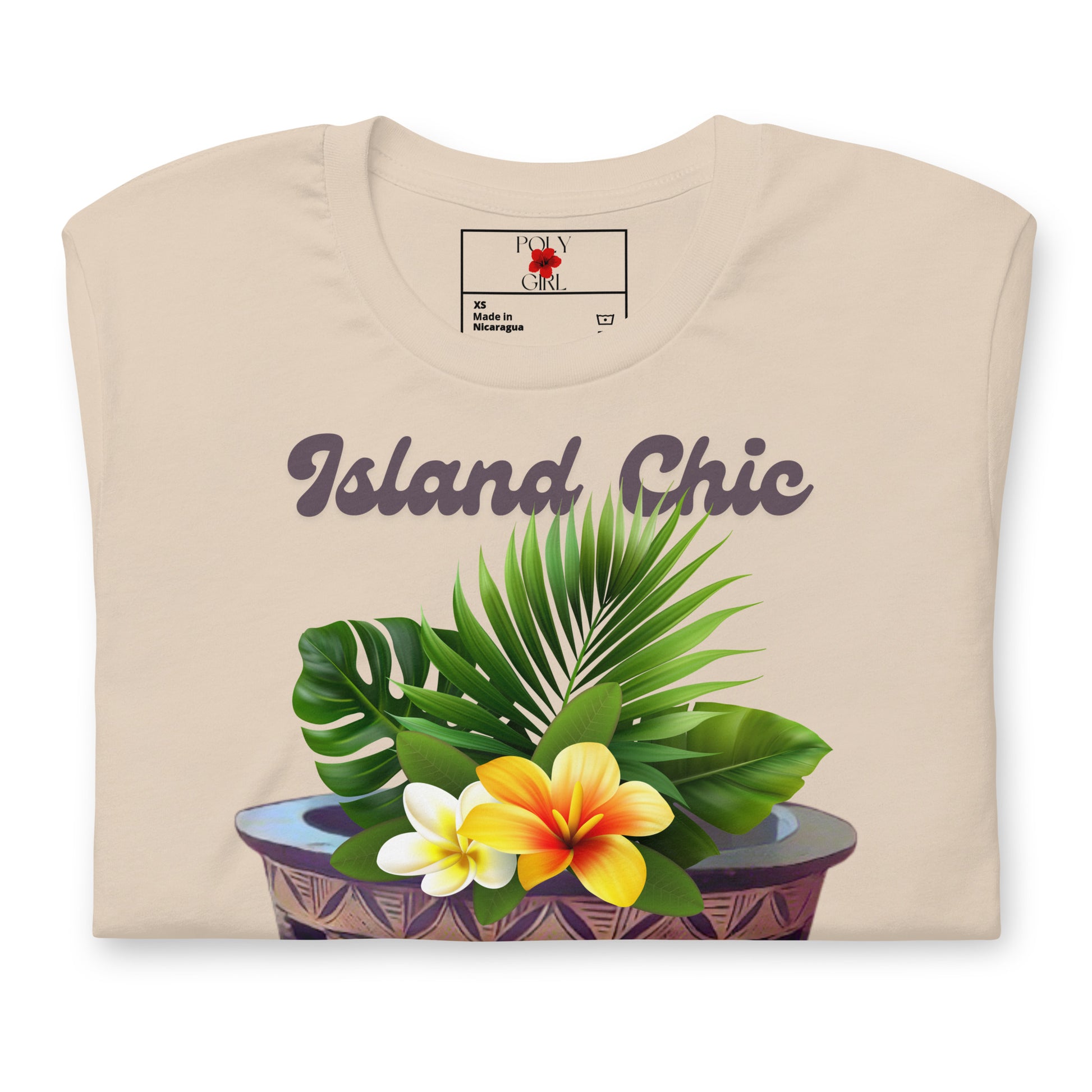 Folded view of Island Chic, Kava Mix tshirt with images of a kava bowl and tropical foliage.