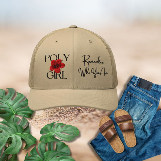 Beige cap with 'Poly Girl' and 'Remember Who You Are' text, paired with jeans and sandals on a neutral background.