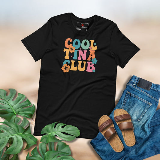 Black t-shirt with 'Cool Tina Club' text, jeans, sandals, and plants on a light background