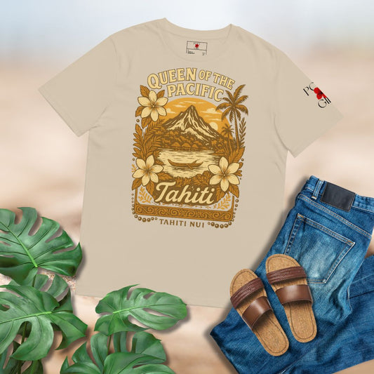 Ladies' Khaki T-shirt by Poly Girl with Tahiti_Queen_of_the_Pacific Design of mountains and water and flowers and coconut trees laid flat on plain background with jeans, sandals, and tropical leaves surrounding it.