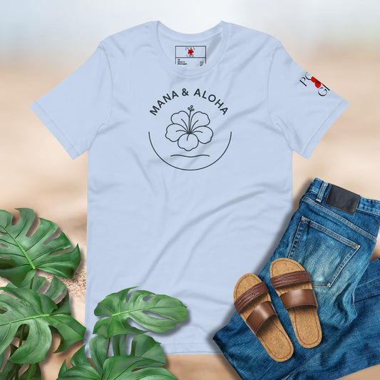 Light blue t-shirt with 'Mana & Aloha' design, paired with jeans and sandals on a neutral background.