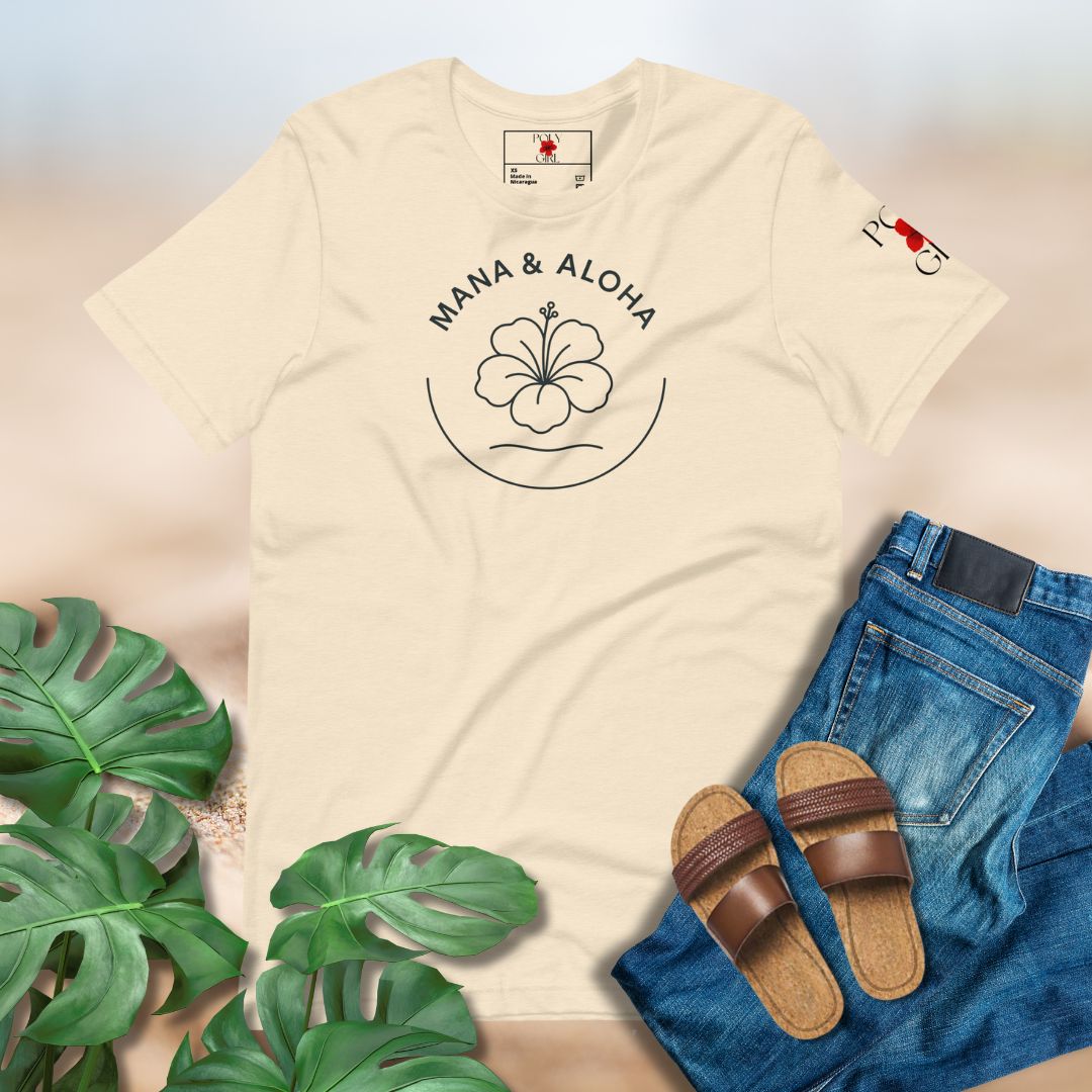 Beige t-shirt with 'Mana & Aloha' design, paired with jeans and sandals on a light background.