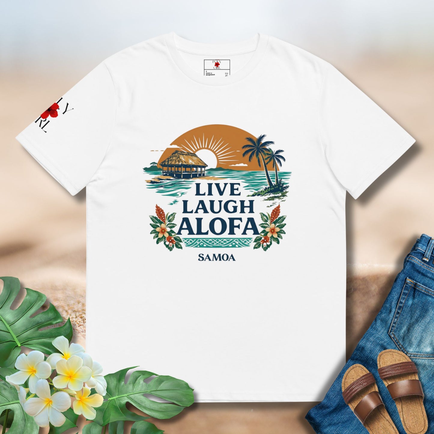 White tshirt with graphic design of Samoan Fale and sunset over the ocean and florals with the words Live Laugh Alofa 