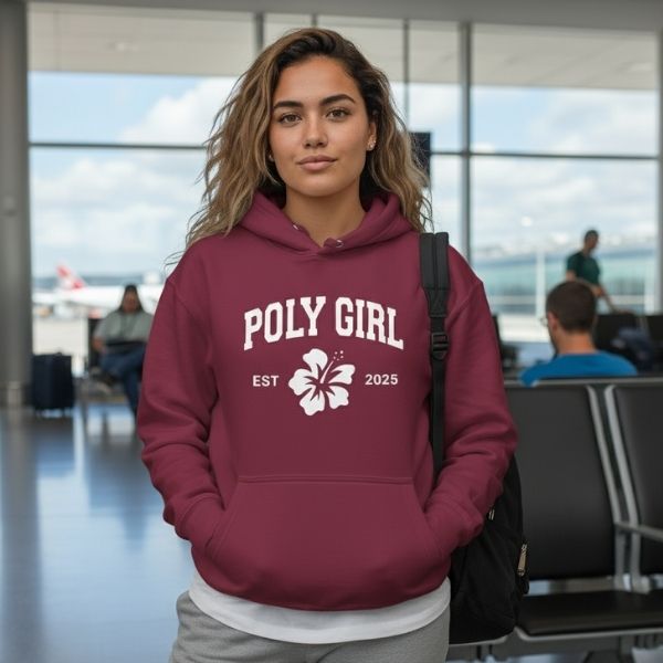 Person wearing a maroon hoodie with 'Poly Girl' text in an airport setting. Poly Girl is the Island Girl's Brand.