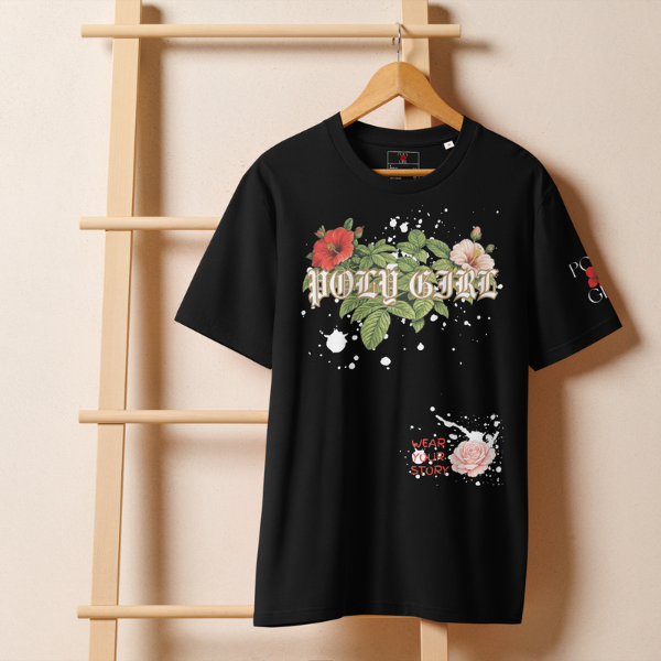 Black t-shirt with floral designs and text on a wooden hanger against a beige wall.