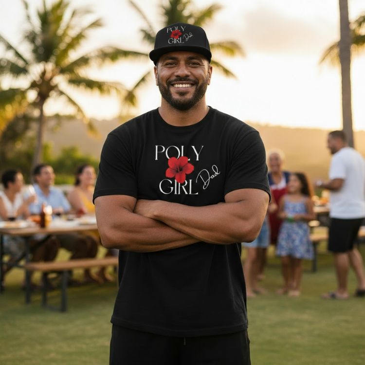 Man wearing a black t-shirt with 'Poly Girl Dad' text and a red flower graphic, standing outdoors with palm trees and people in the background.
