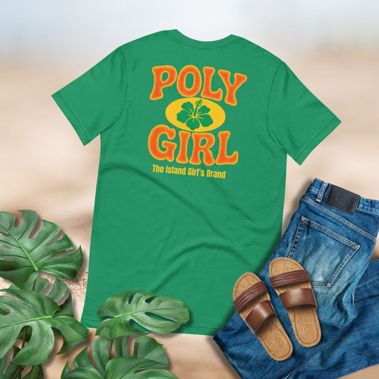Green t-shirt with hibiscus emblem and Poly Girl, The Island Girl's Brand design surrounded by jeans, brown slippahs, and green tropical foliage. 