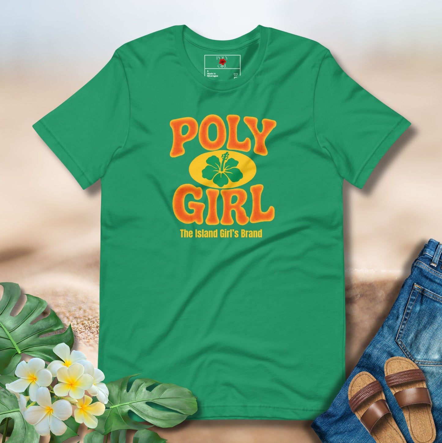 Green t-shirt with 'Poly Girl' text and branding on a neutral background with floral and denim elements.