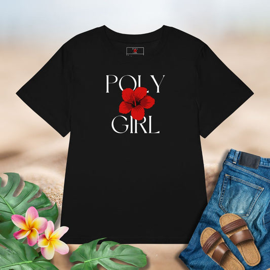 Black t-shirt with 'POLY GIRL' logo of a red hibiscus graphic on a neutral background with plants and sandals.
