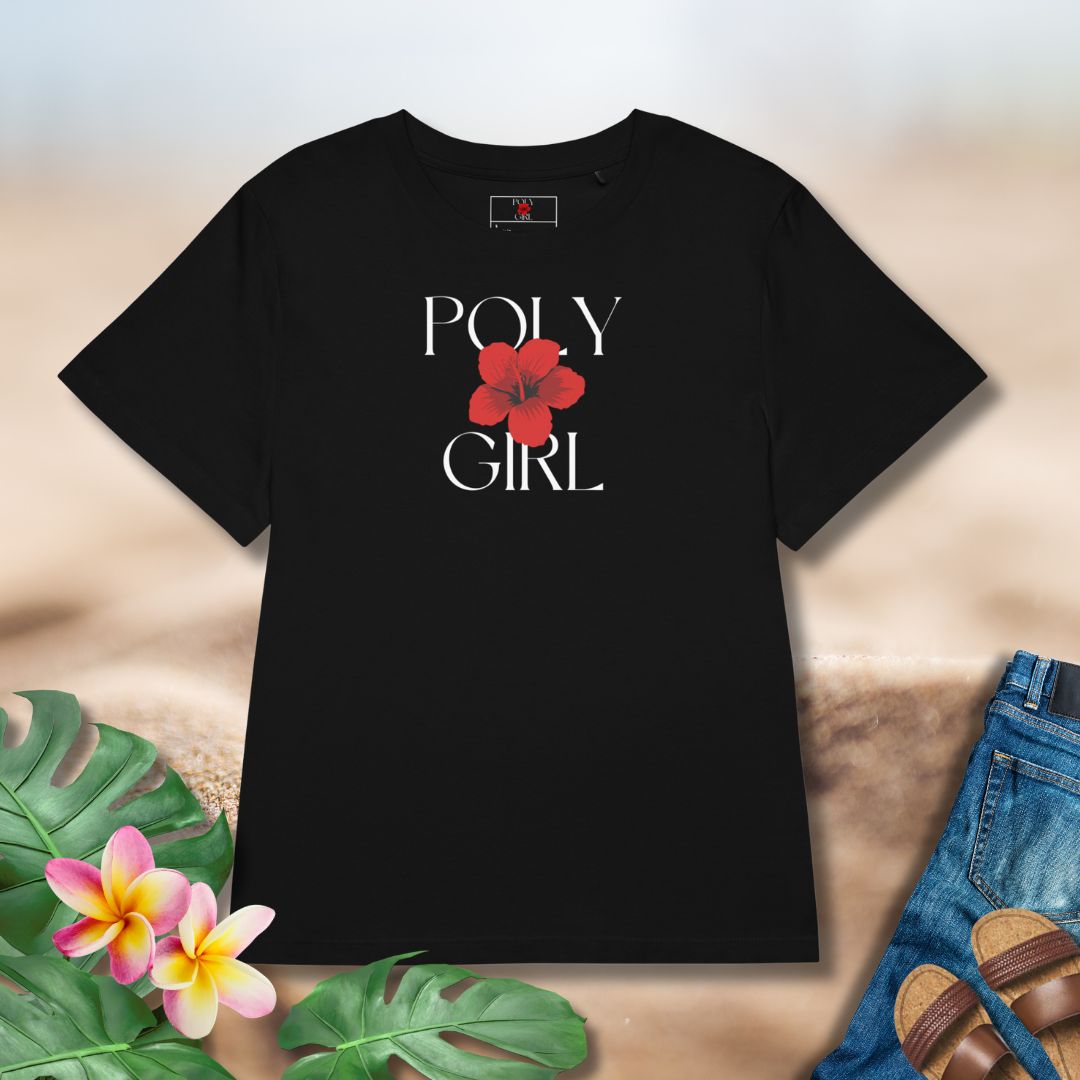 Black t-shirt with 'POLY GIRL' and a red flower graphic on a neutral background with floral and sand elements. Polynesian and Pacific Island brand. 