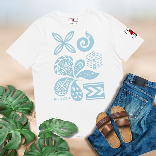 White t-shirt with blue floral patterns of Polynesian and Pacific Island motifs paired with jeans and sandals on a light surface.
