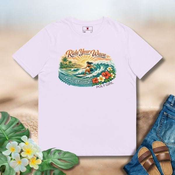 Lavender tee featuring an island surf illustration with a woman riding a wave, tropical florals, sun, and Poly Girl logo.