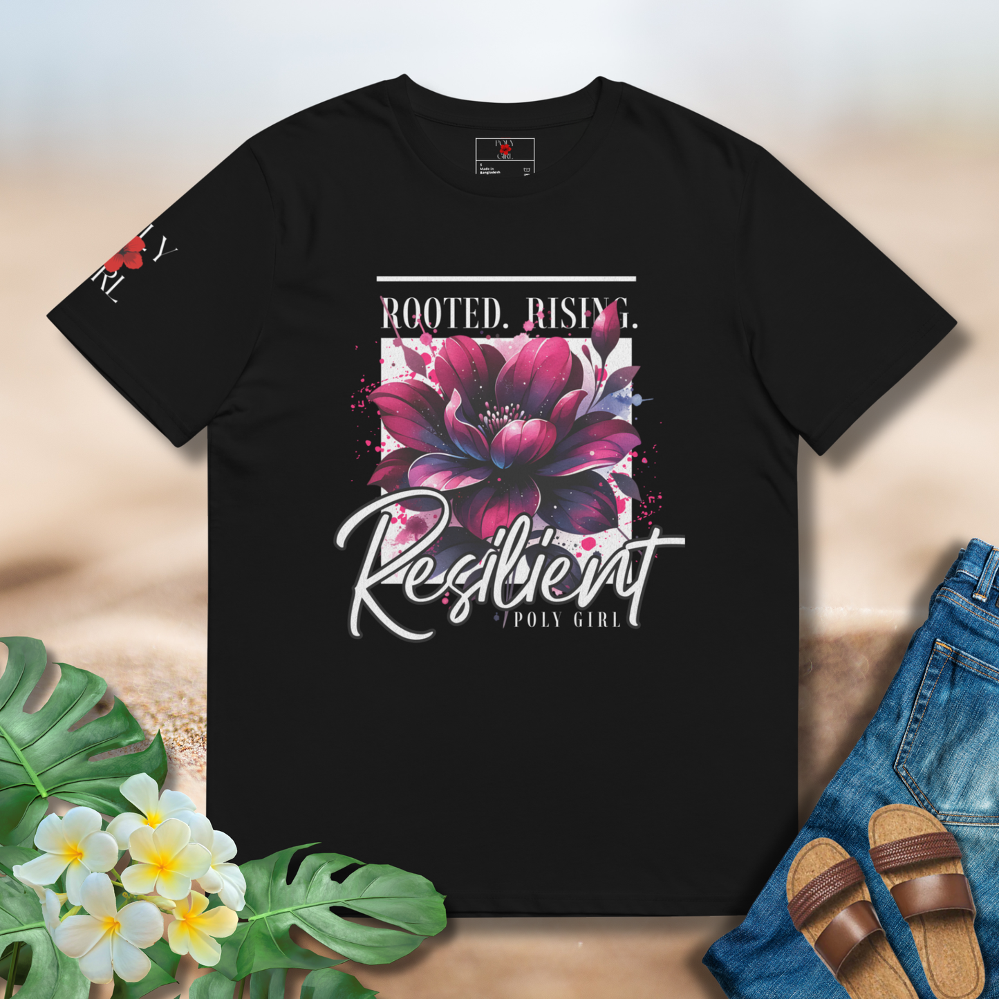 Desing of purple flower and the words Rooted, Rising and Resilient on a black tshirt