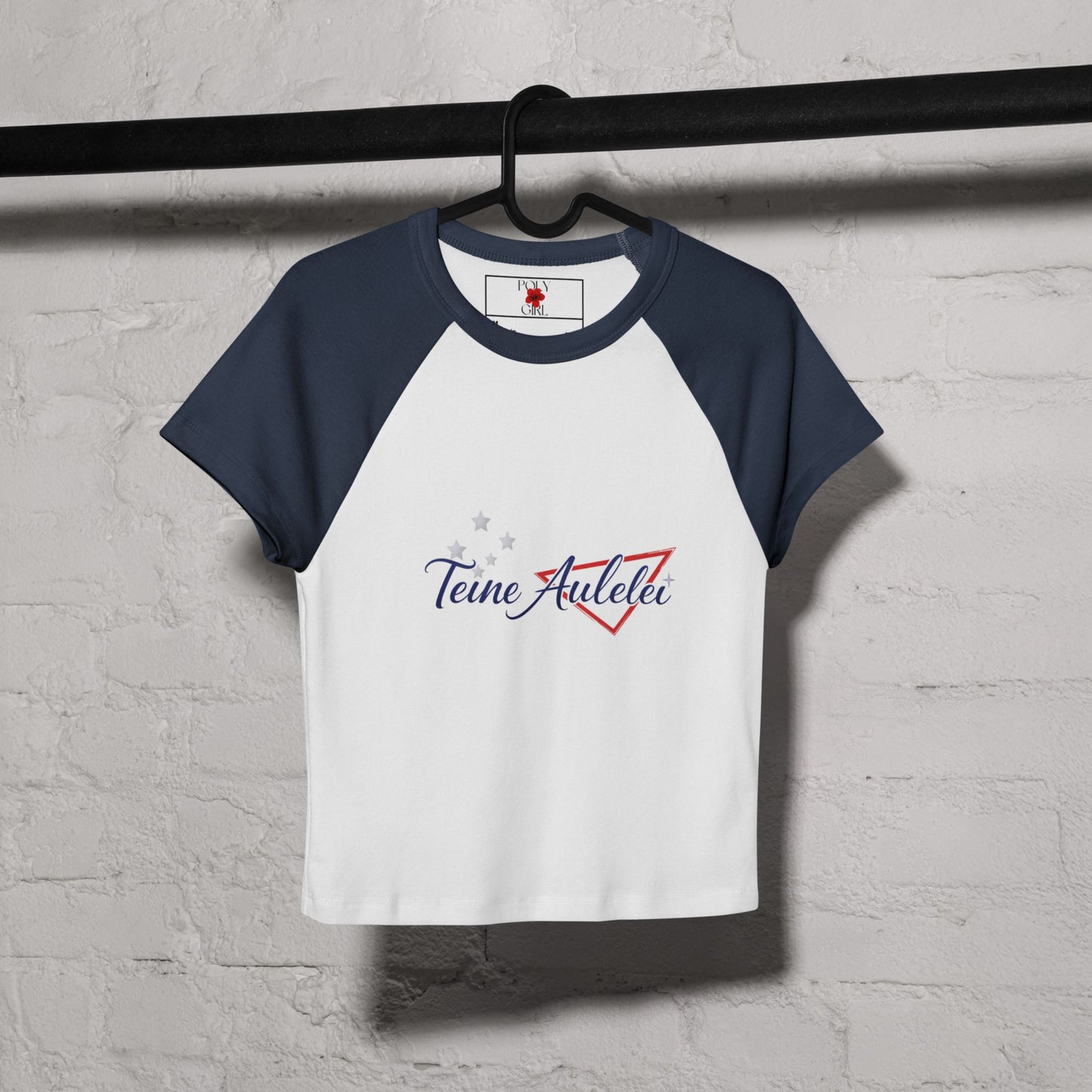 Teine Aulelei Baby Tee by Poly Girl in Blue hanging on hanger