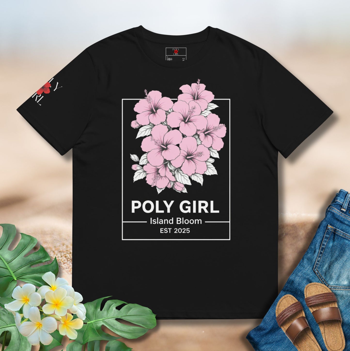 Vintage Island Bloom Black Tee with clusters of pink hibiscus in white outline and Poly Girl name and Island bloom EST 2025 on the bottom. 