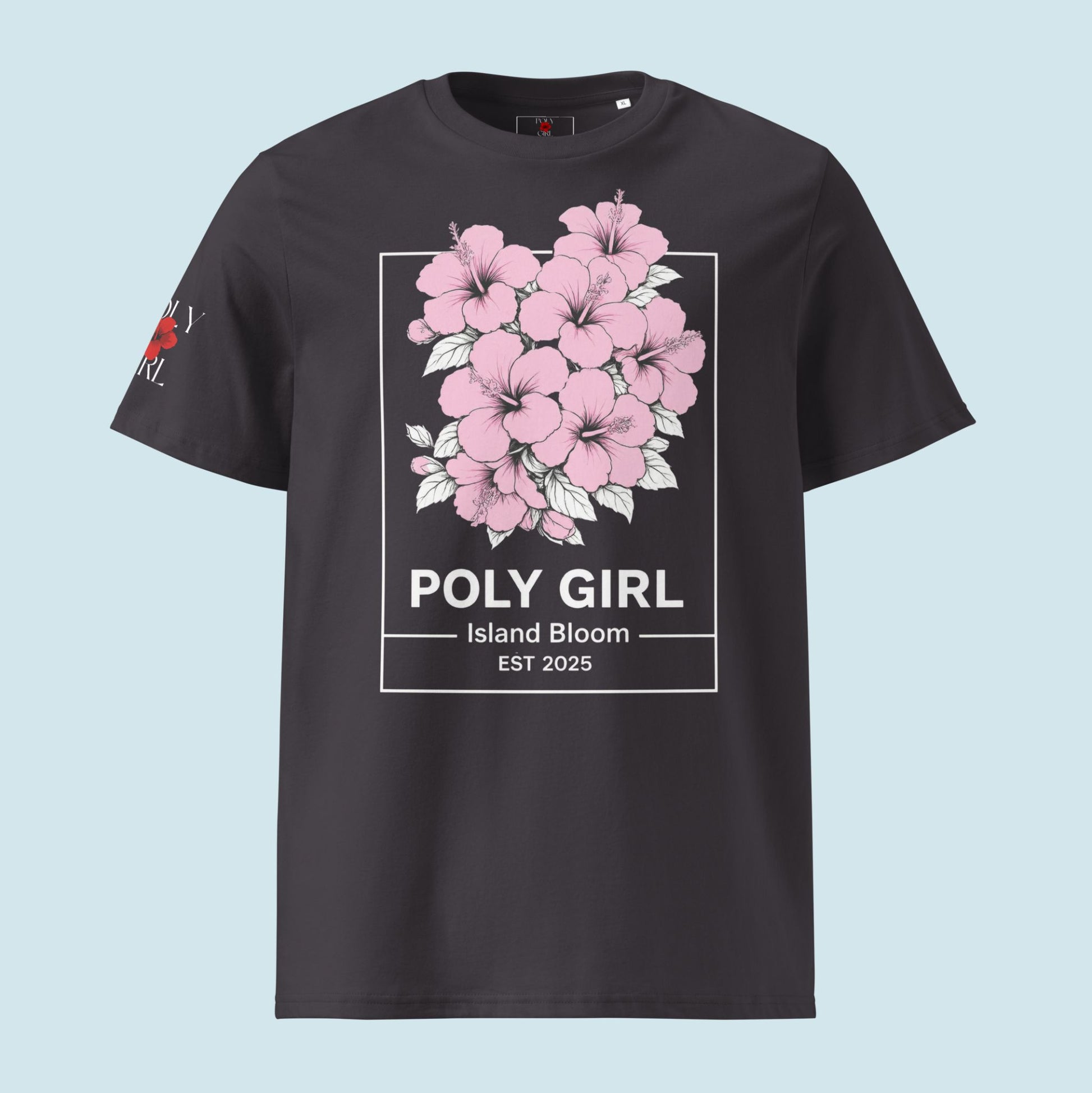 Close up of dark gray/purple Vintage Island Bloom Tee with clusters of pink hibiscus in white outline and Poly Girl name and Island bloom EST 2025 on the bottom. 